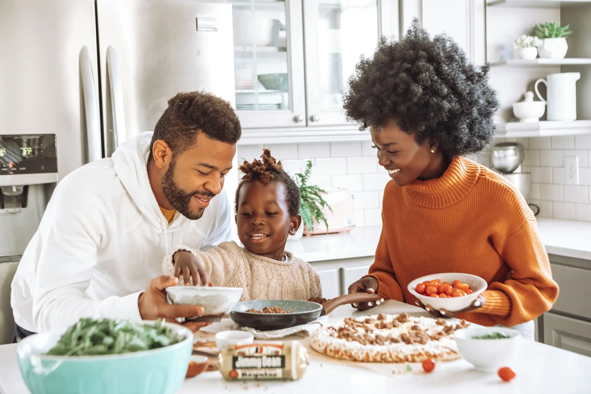 Parents and daughter enjoying a meal in their kitchen